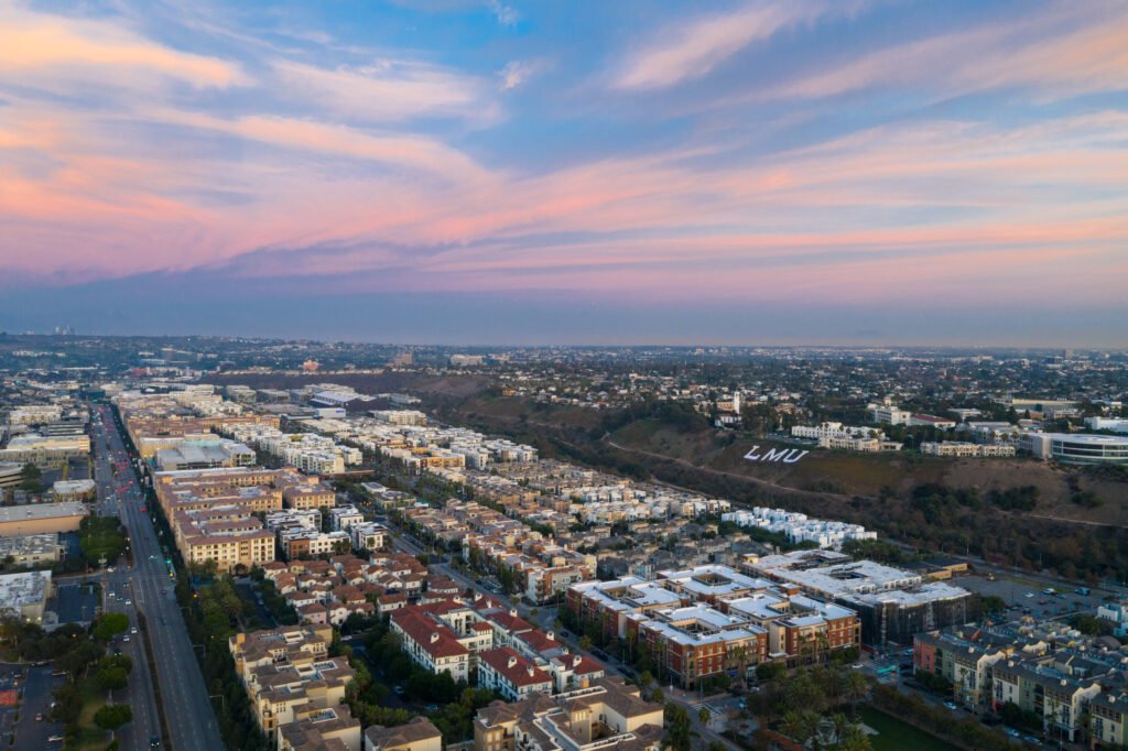 Aerial view of Playa Vista at sunset, with the Westchester bluffs and LMU above
